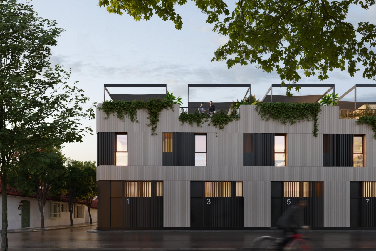 En aftenudsigt over bebyggelsen, der viser dens varme belysning og elegante arkitektur.