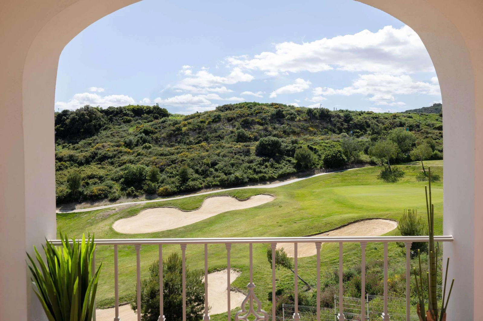 Relax on your balcony with serene views of the lush golf course.