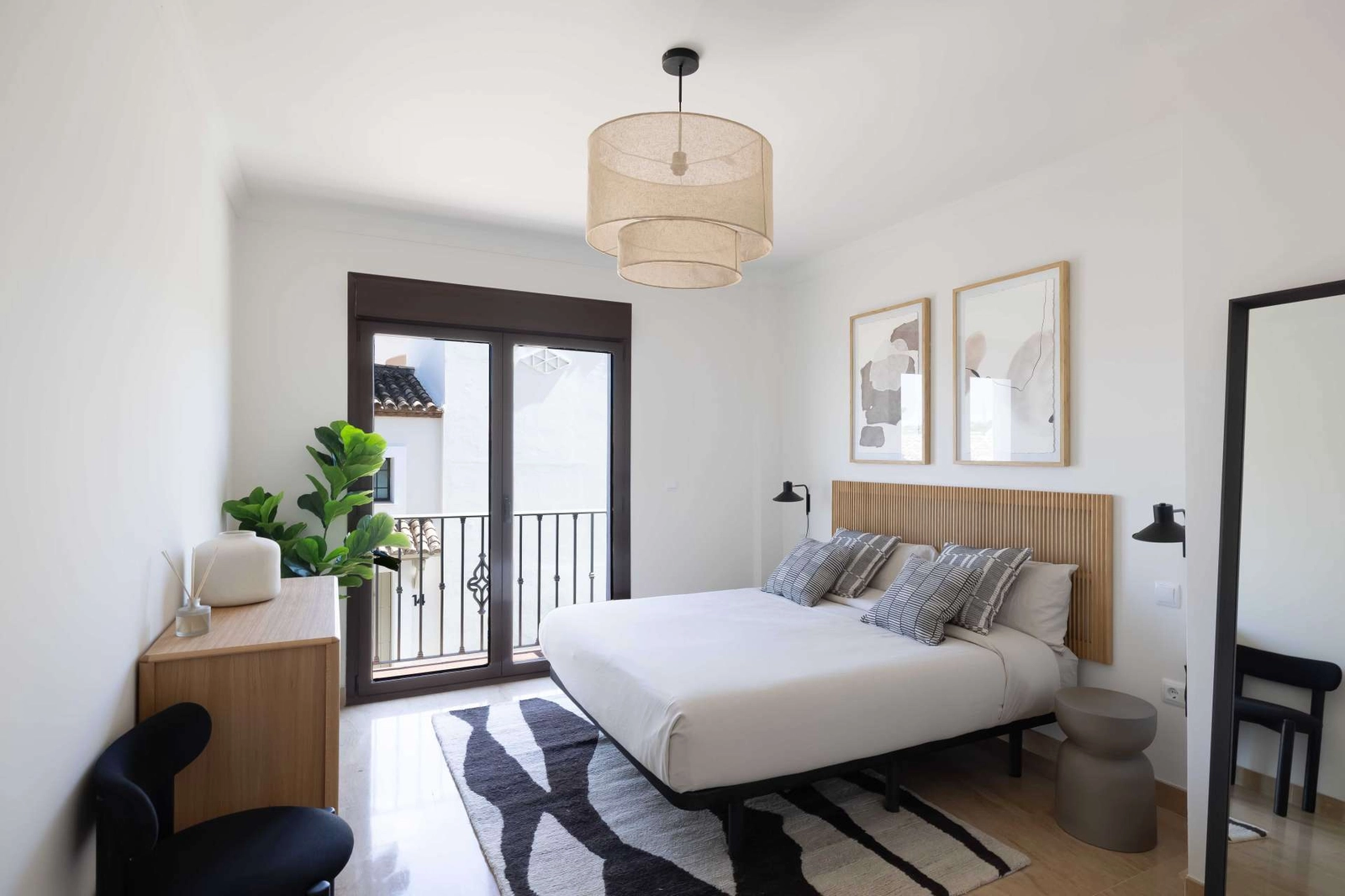The elegant master bedroom offers a tranquil retreat with access to a private balcony.
