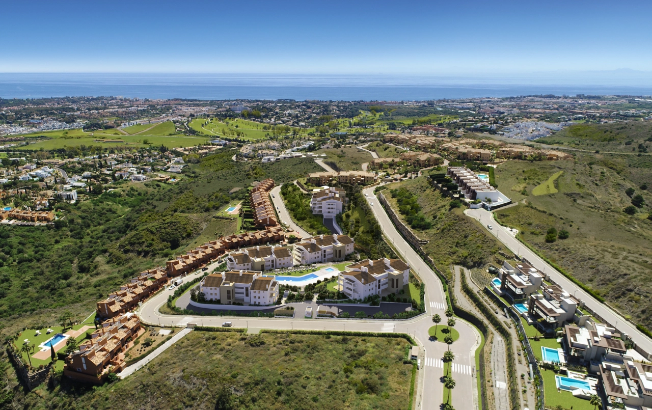 An elevated view of the development, showcasing its privileged position on the Costa del Sol with the Mediterranean Sea beyond.