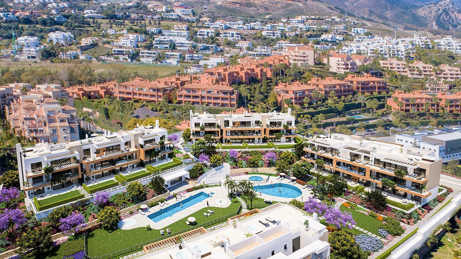 An aerial view of the development, showcasing the lush gardens and stunning pool areas.