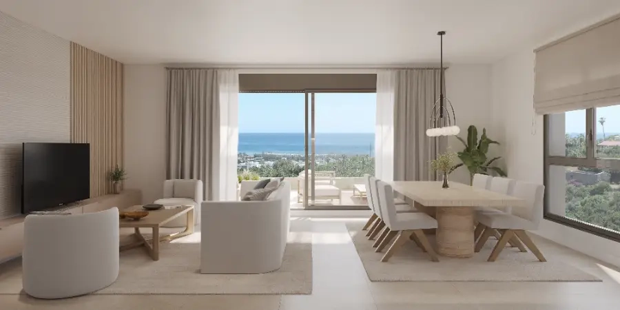 The bright and spacious living area seamlessly connects to the terrace, framing the spectacular sea views.