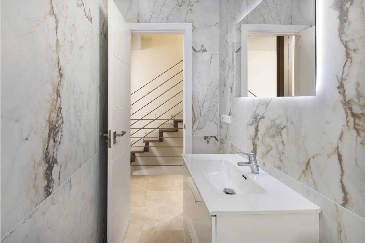 A modern guest bathroom featuring stylish tiling and quality fittings.