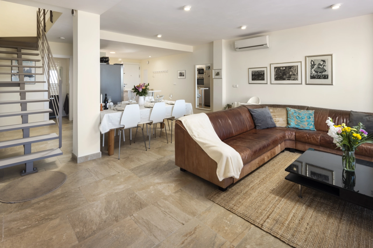 The open-plan living and dining area is bright, spacious, and perfect for modern living.