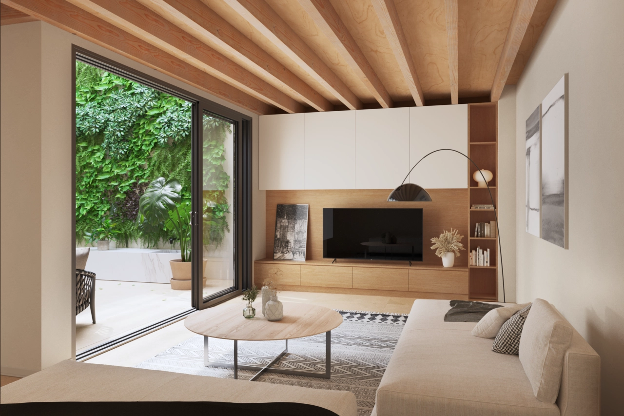A stylish living room looks onto the tranquil interior patio with a green wall.