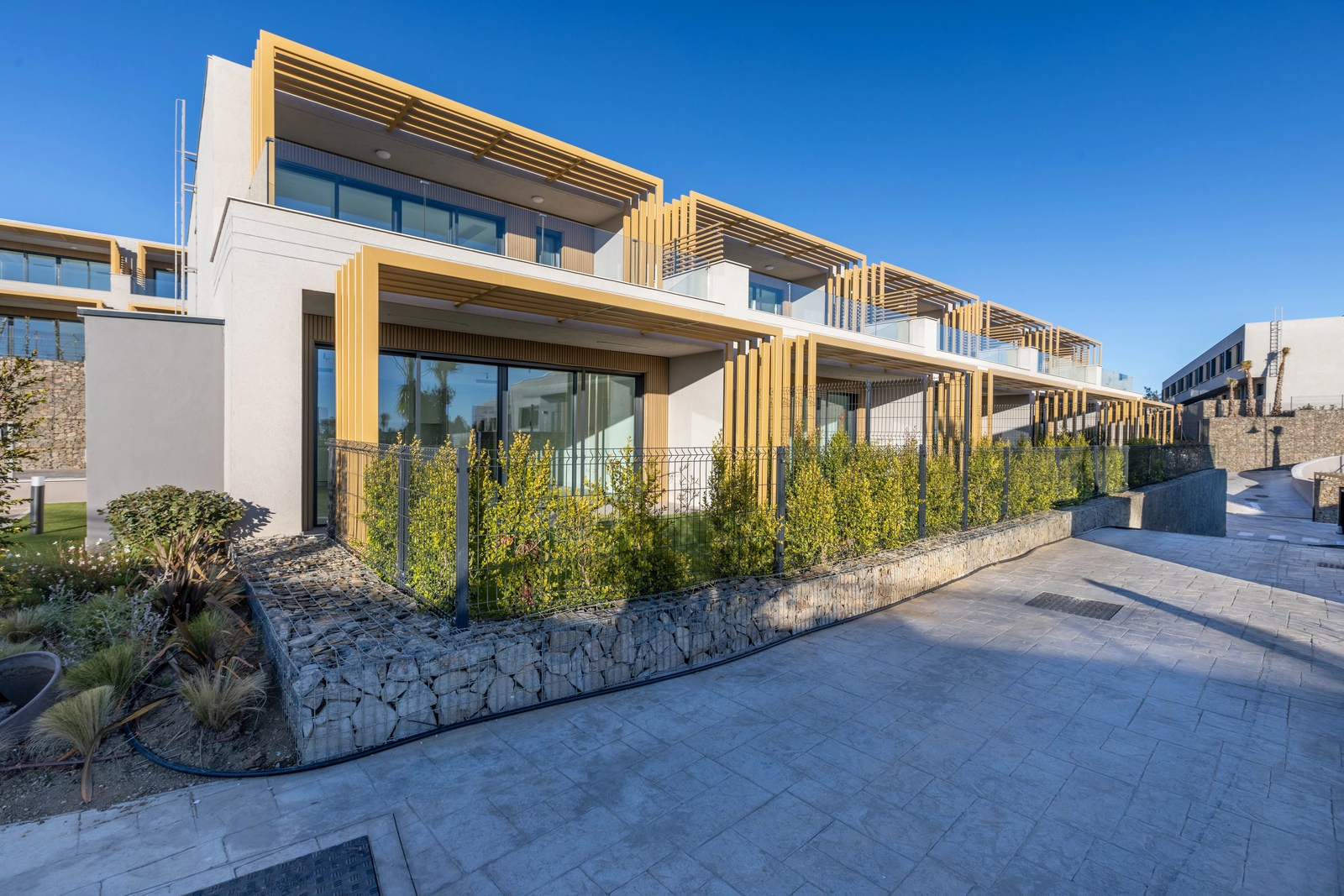 Contemporary architecture blends with the landscape, featuring clean lines and natural materials.
