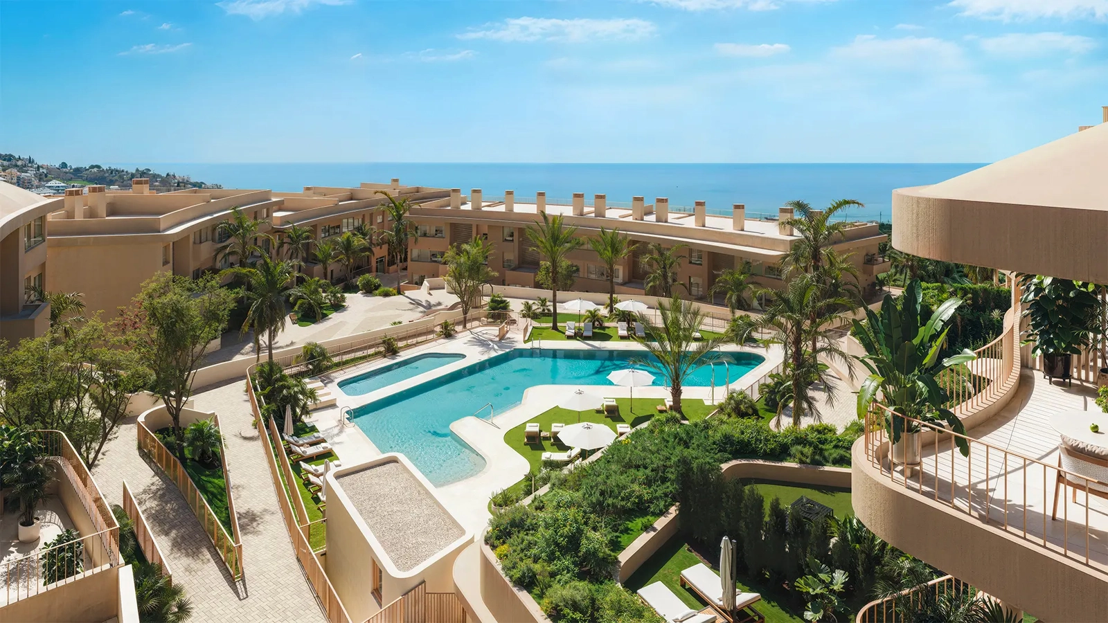 Communal pool area with blue water meeting the horizon of the Mediterranean Sea.