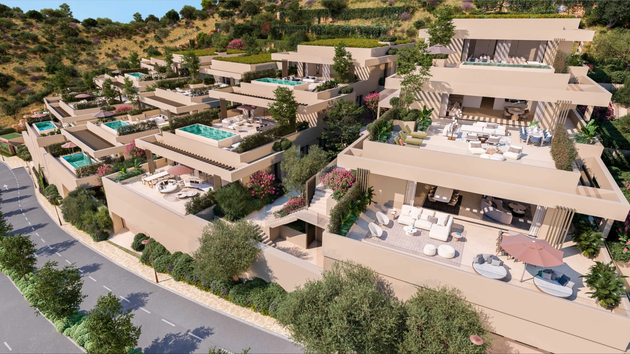 The development's organic architecture blends harmoniously with the surrounding hills of the Costa del Sol.