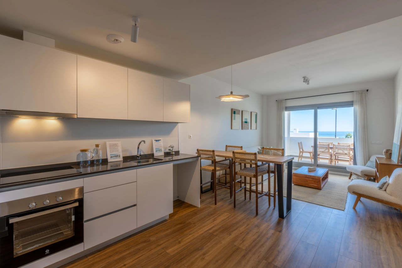 A modern, fully-equipped kitchen opens into the living area, creating a bright and sociable heart of the home.