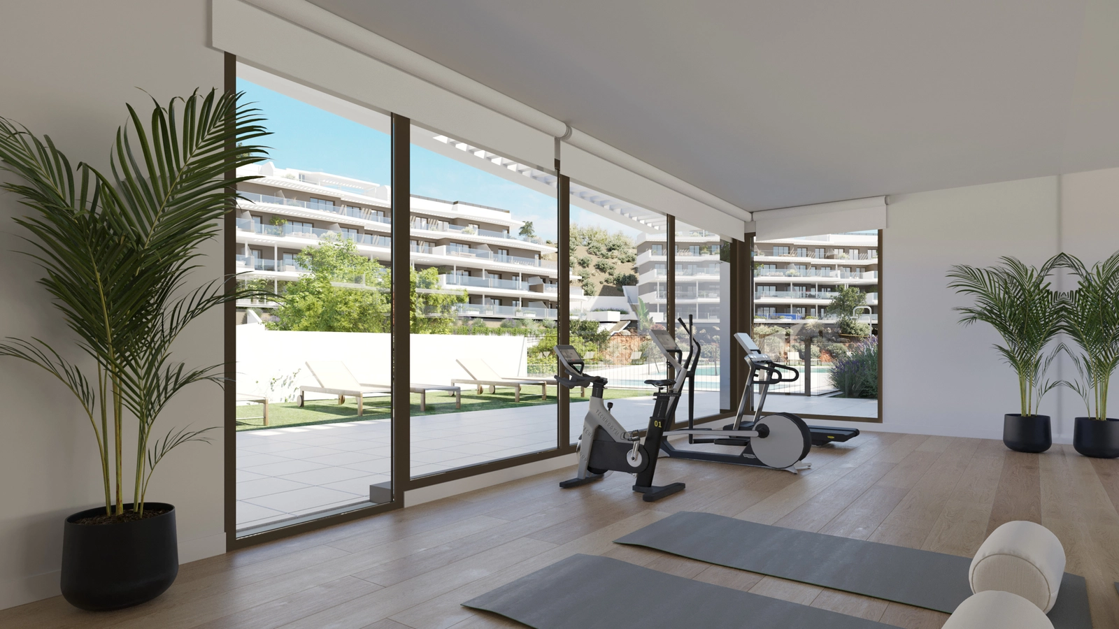 The fully equipped residents' gym, with large windows overlooking the gardens and pool area.