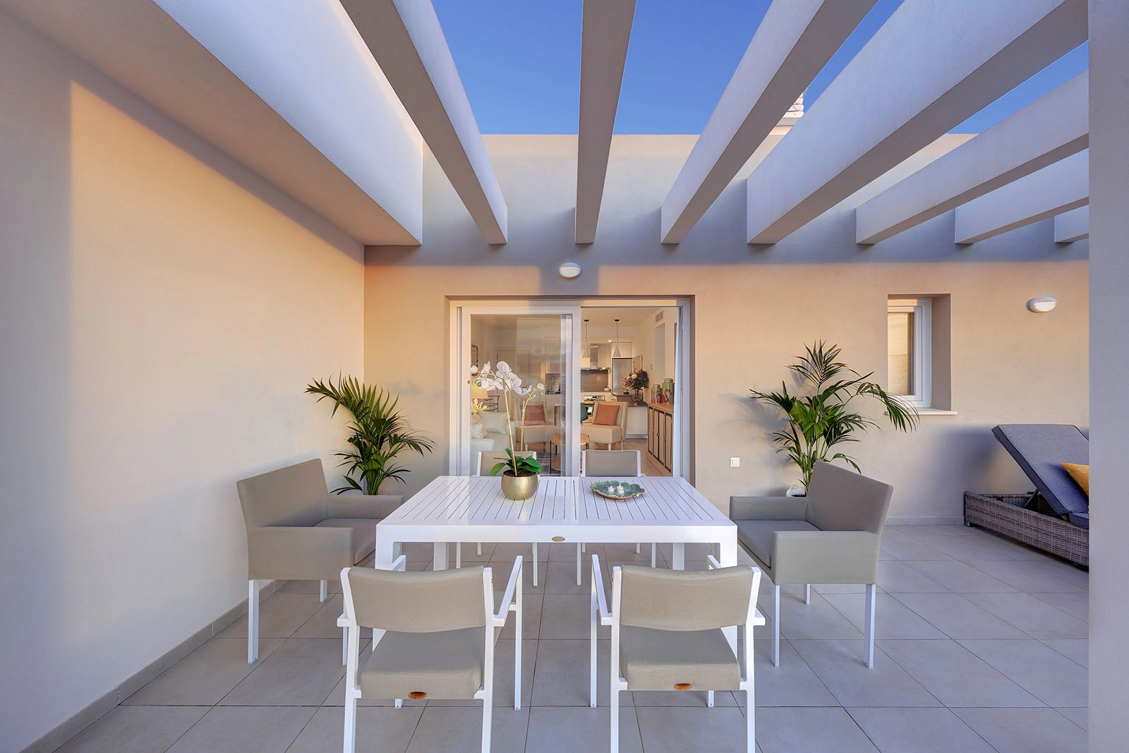 The terrace provides a perfect setting for al fresco dining, seamlessly connecting with the indoor living space.