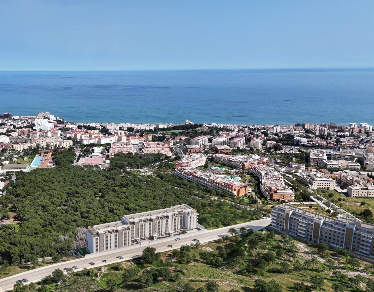 An aerial view showing the development's prime location, nestled between green spaces and the sea.
