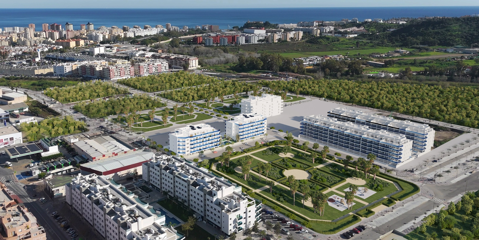 An aerial perspective of the Laguna One development, showing its integration into the surrounding green landscape and proximity to the sea.