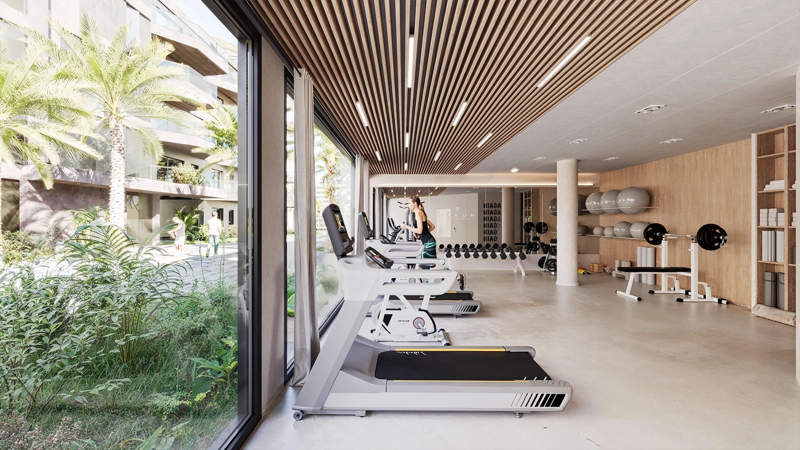 Pursue your wellness goals in the state-of-the-art fitness center, fully equipped for a comprehensive workout overlooking lush gardens.