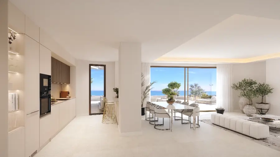 An open-plan kitchen and dining area in a penthouse, designed for effortless entertaining with sea views.