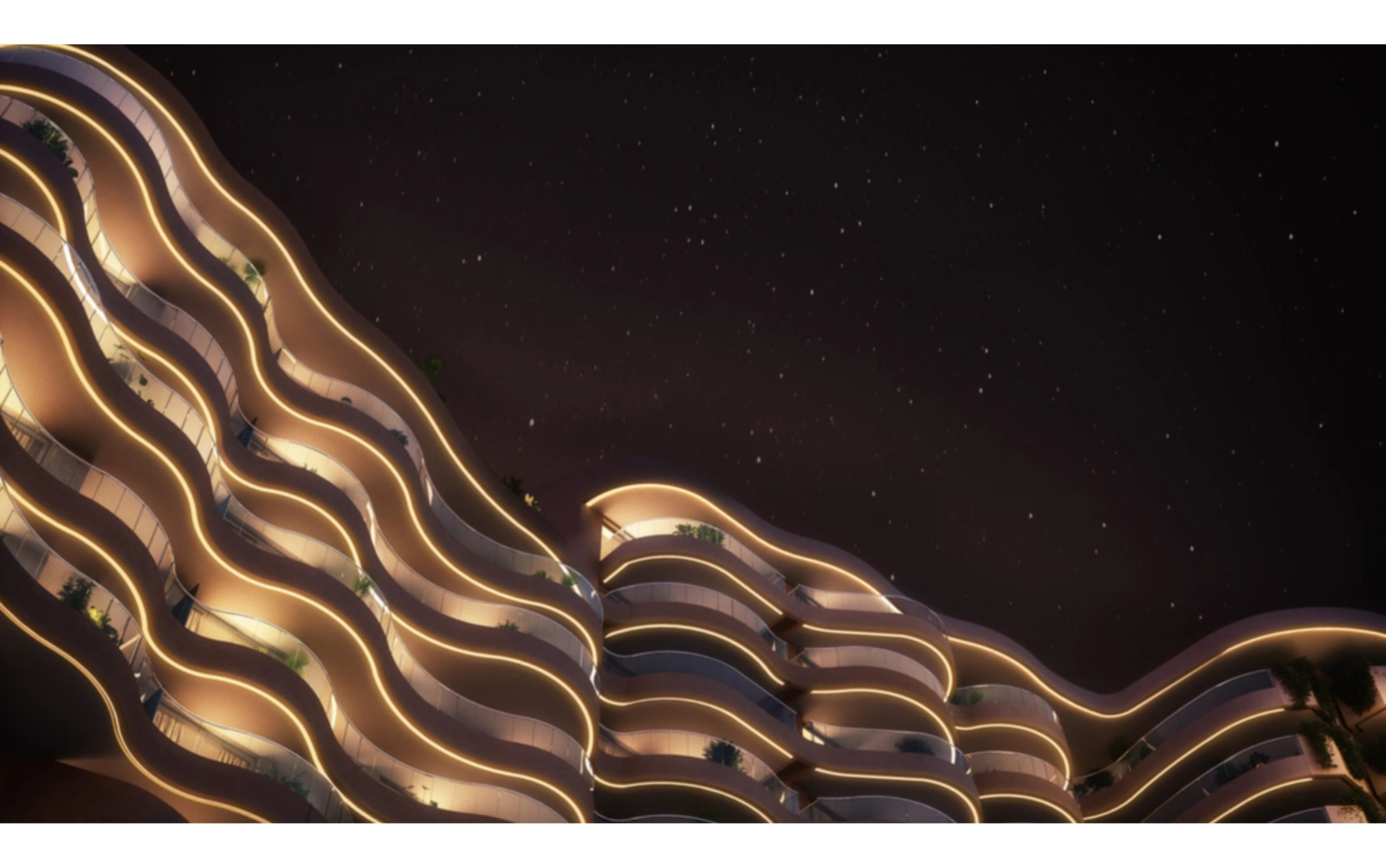 The building's distinctive wave-like architecture is beautifully illuminated at night.