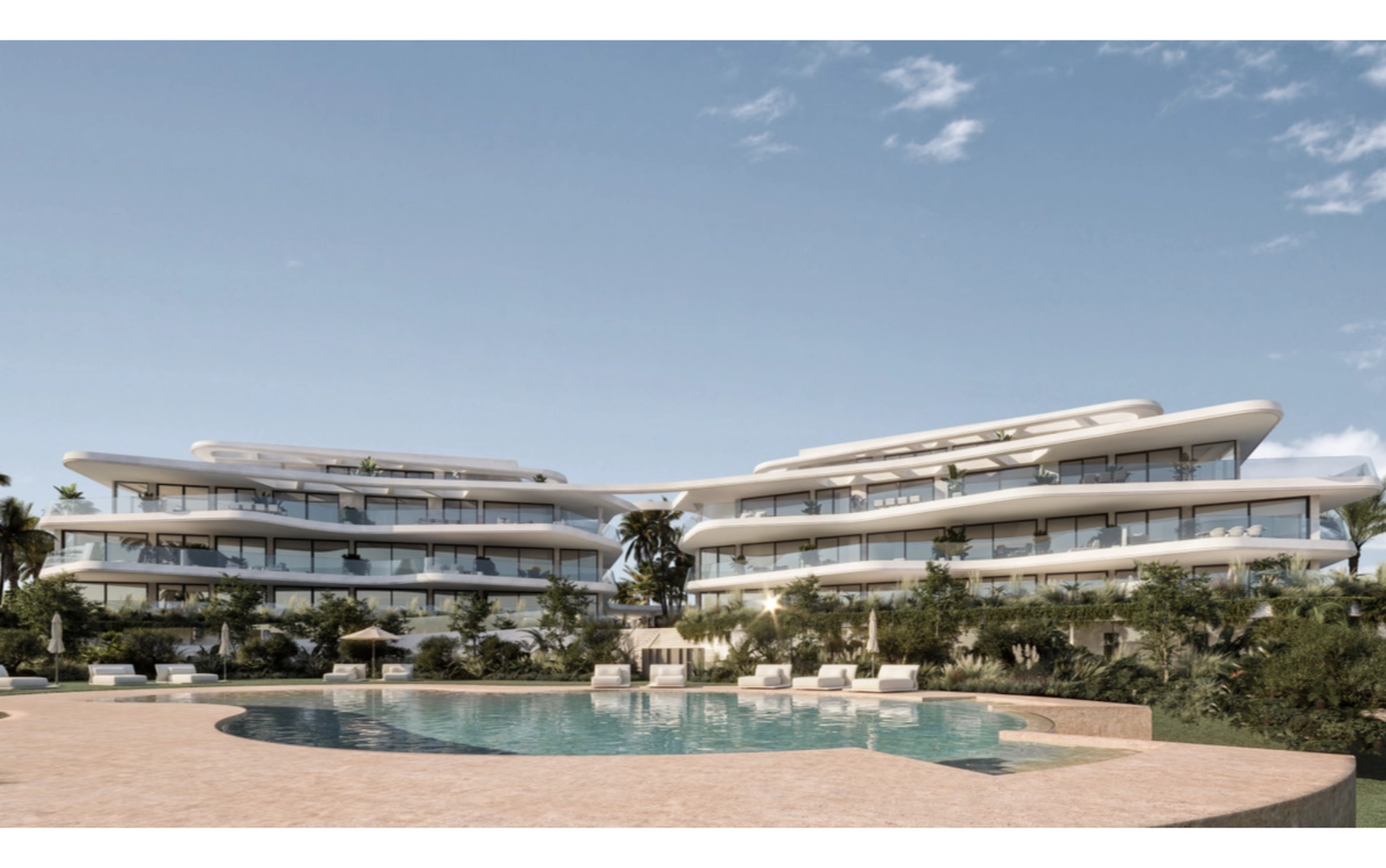 The inviting beach-entry swimming pool is surrounded by lush, landscaped gardens.