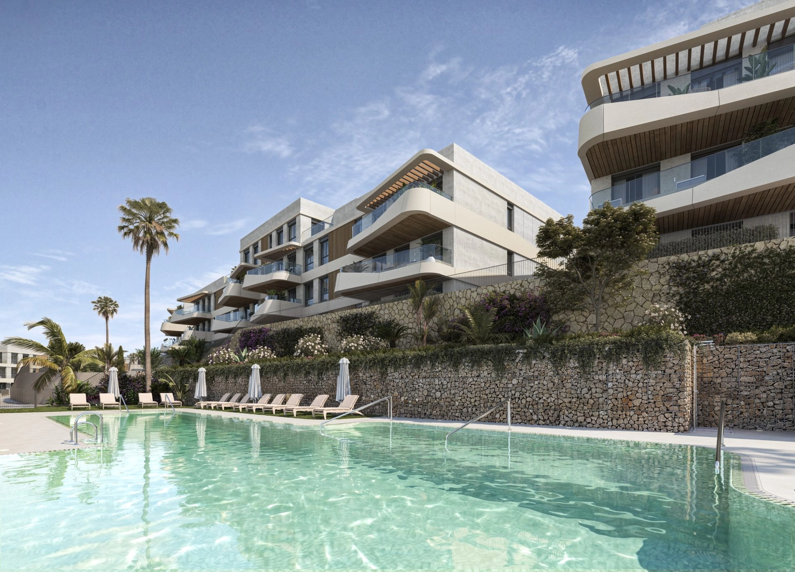 One of two saltwater swimming pools, surrounded by lush gardens and sun loungers.