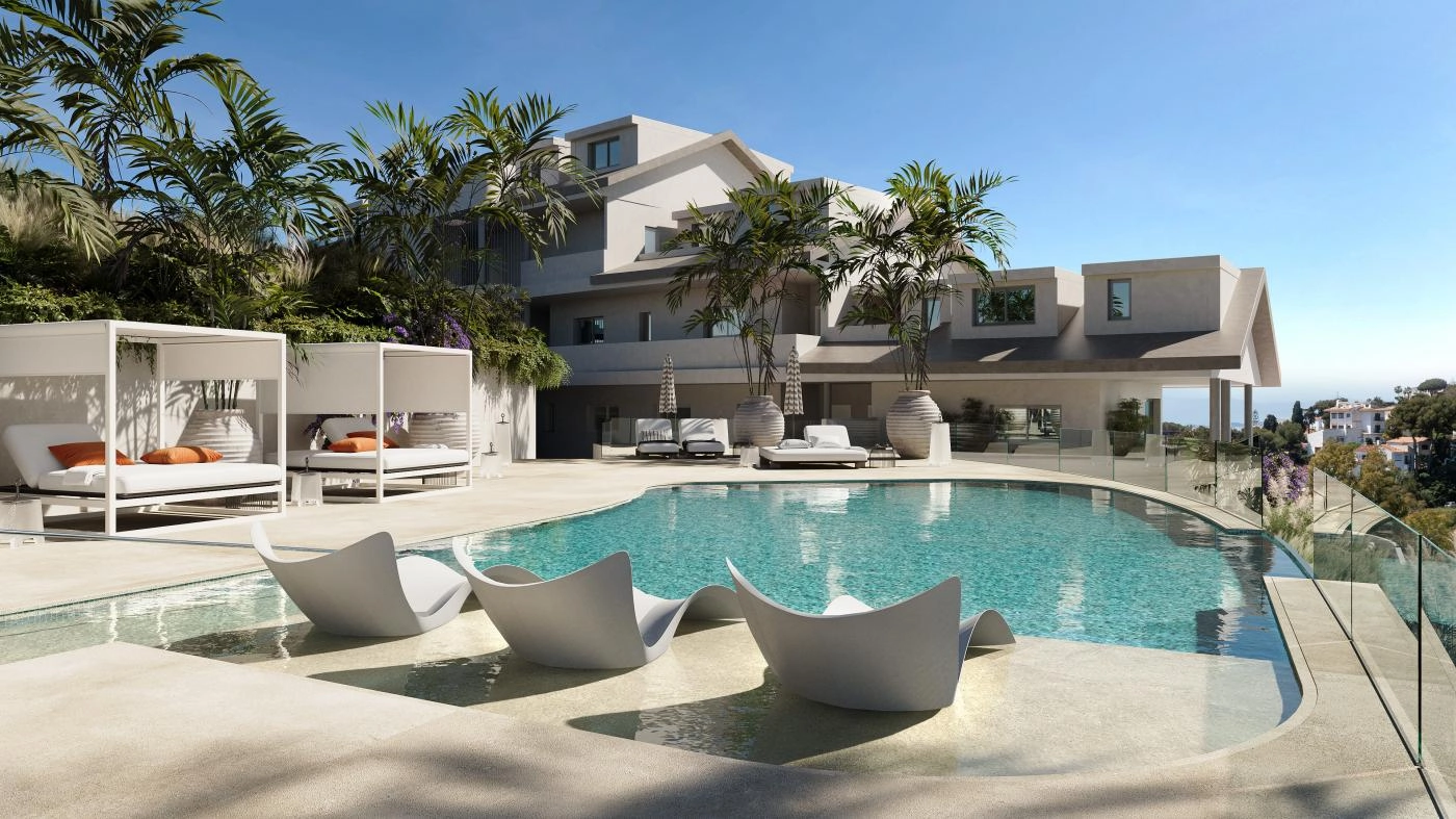 The communal pool area offers a refreshing escape, complete with comfortable sun loungers.