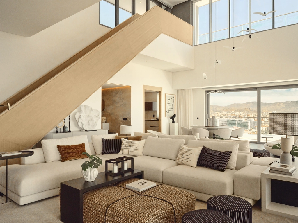 The double-height living area creates a sense of grandeur and space, with expansive windows framing the city and sea.