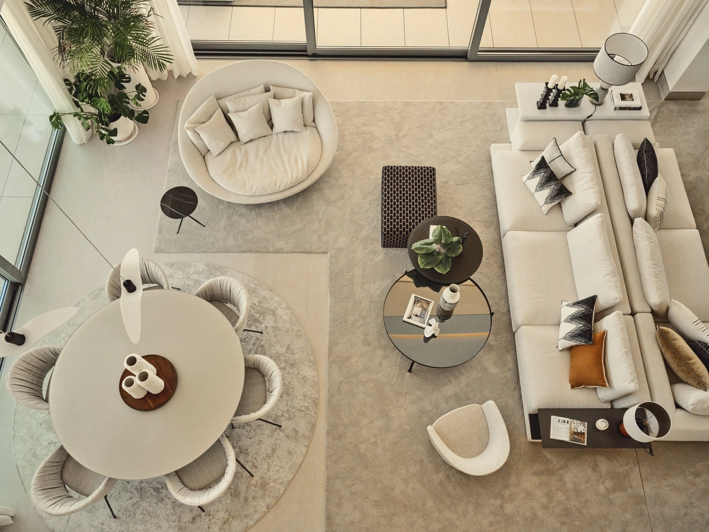 An aerial view of the spacious, open-plan living and dining area, designed for modern comfort and effortless entertaining.