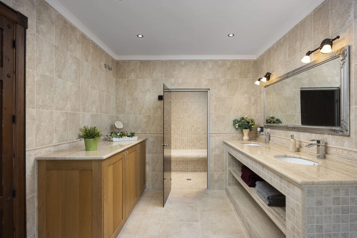A luxurious bathroom featuring a double vanity and access to a private Turkish bath for ultimate relaxation.