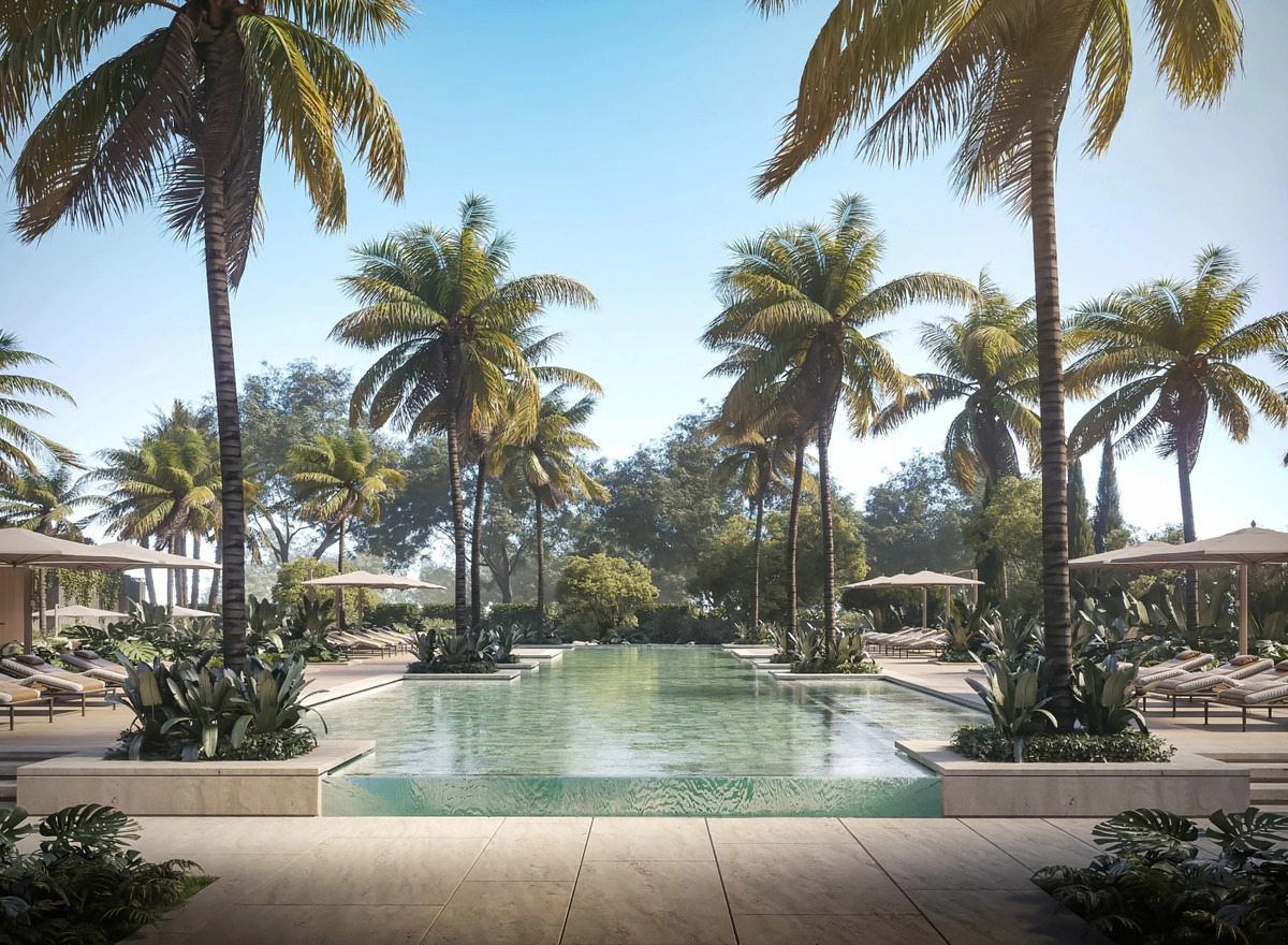 Lush palm trees and curated gardens create a tropical oasis atmosphere.