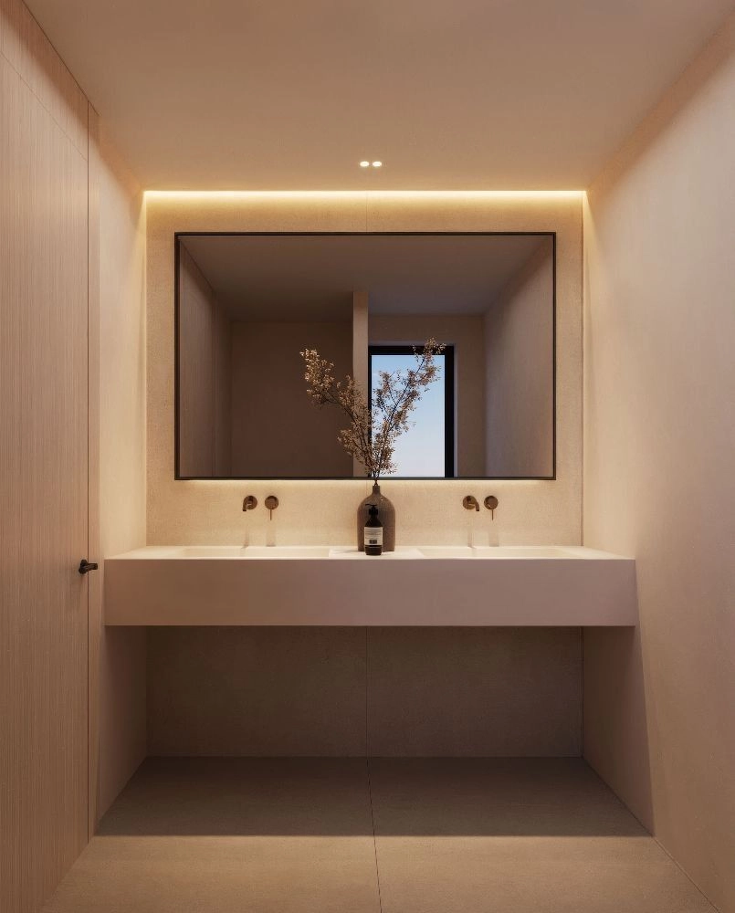 A modern bathroom with clean lines, dual sinks, and elegant backlighting, creating a spa-like atmosphere.