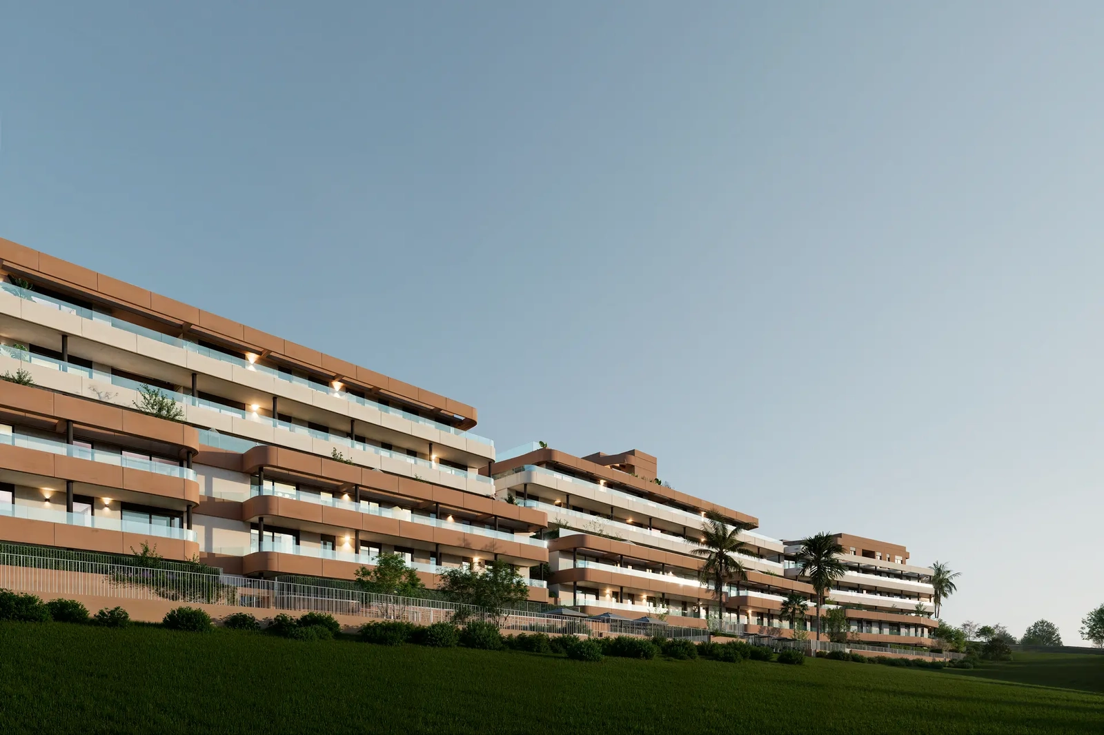 The elegant design of the buildings, set against the green landscape of the Estepona golf course.