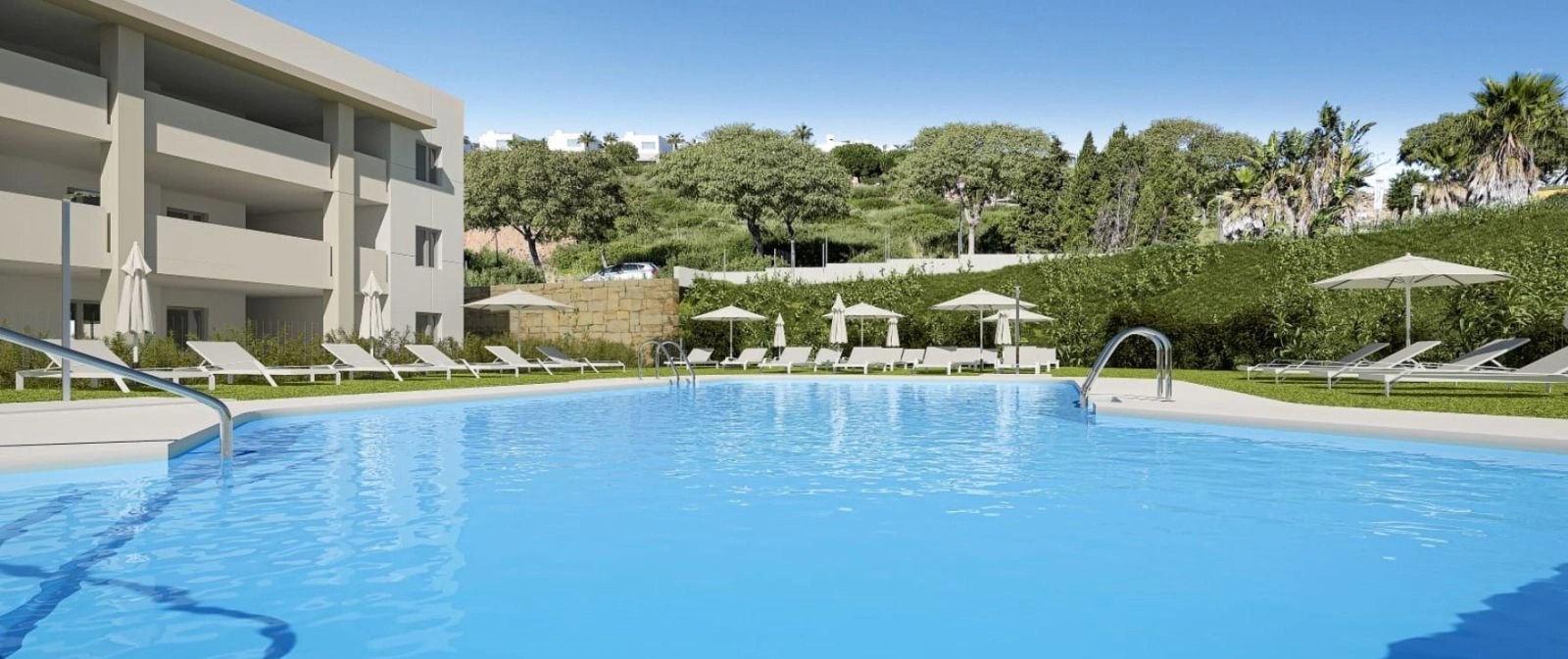 The beautiful communal swimming pool is a perfect oasis for relaxation, surrounded by manicured lawns.