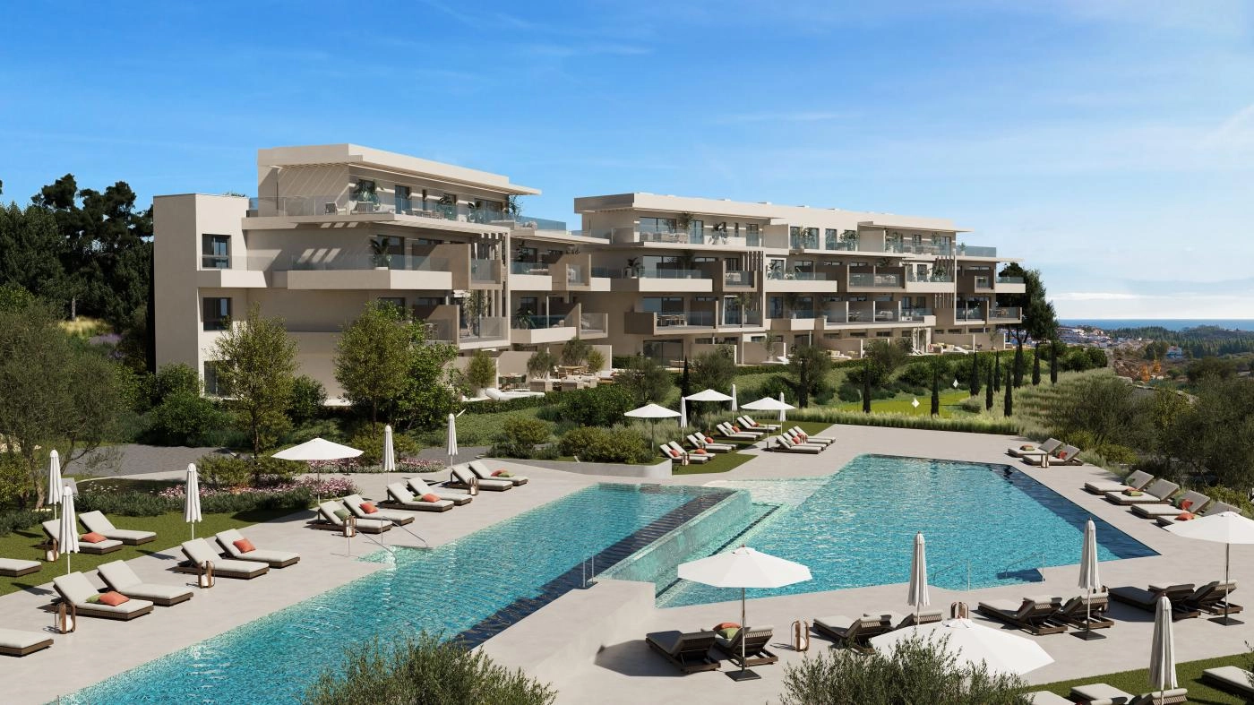 The expansive communal swimming pool area, surrounded by sun terraces and landscaped gardens for residents to enjoy.