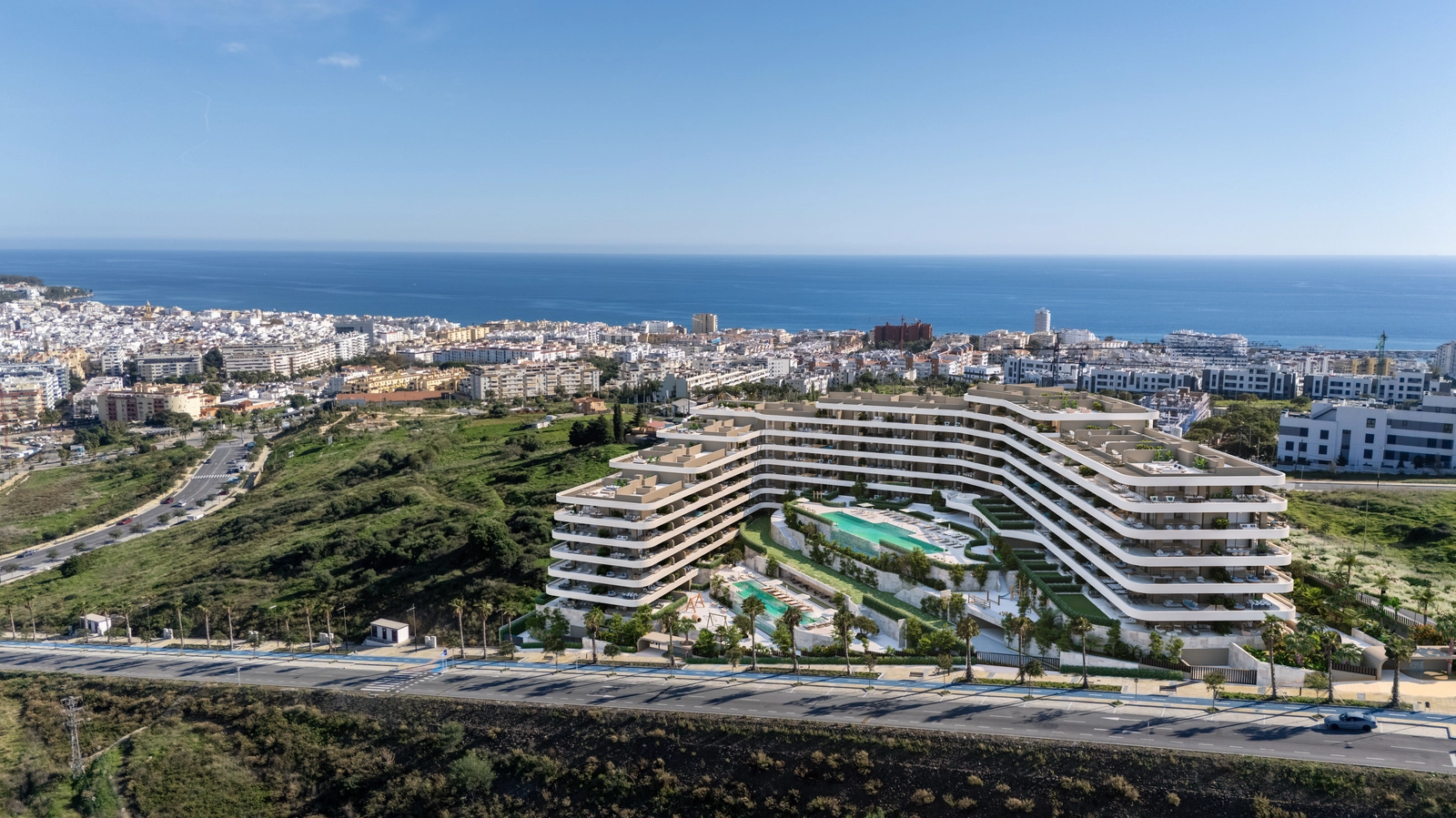 An aerial view of the development, showcasing its unique architecture and privileged position overlooking the sea and Estepona.