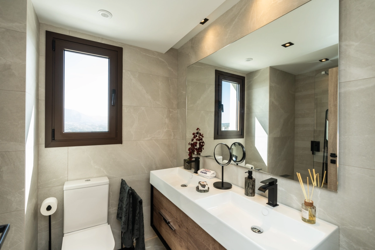 The main bathroom features a double vanity and elegant, modern design details.