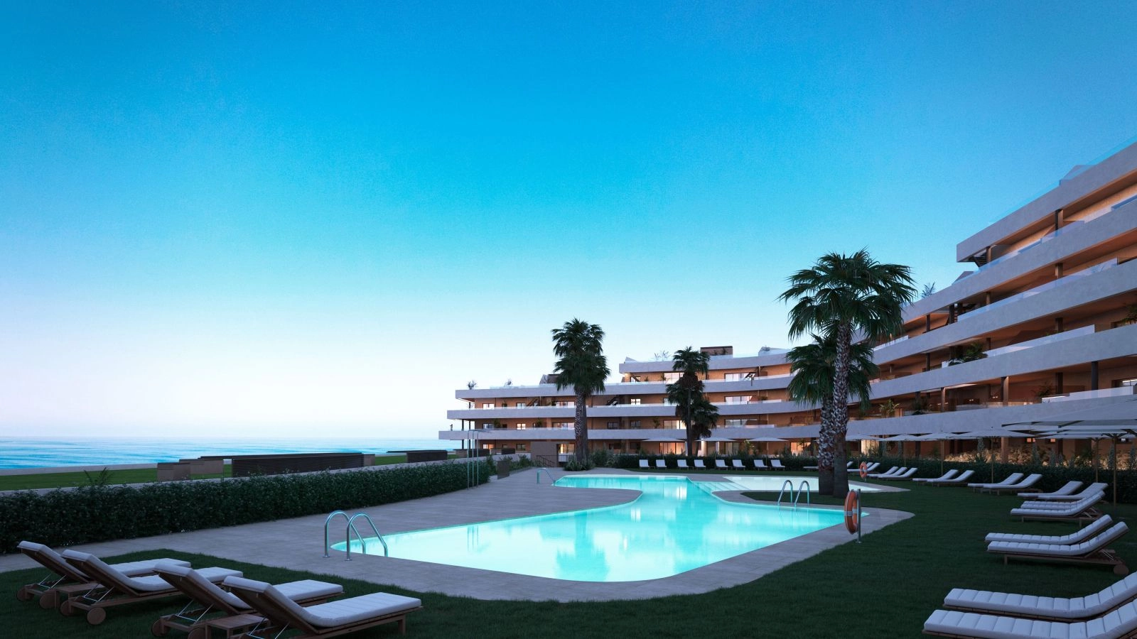 The inviting communal swimming pool area, beautifully lit as evening approaches.