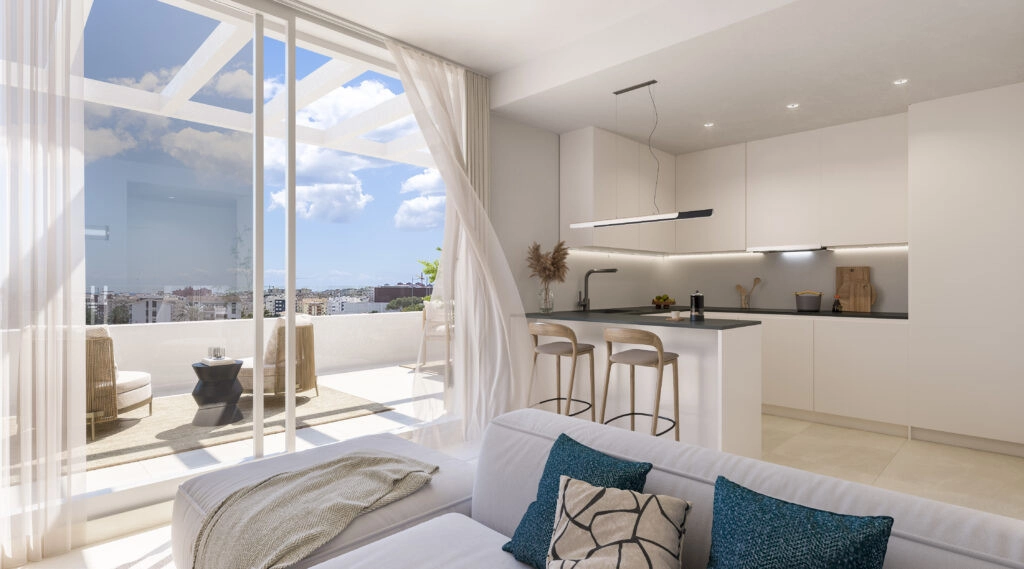 Sunlight fills the open-plan living area, seamlessly connecting the interior with the spacious outdoor terrace.