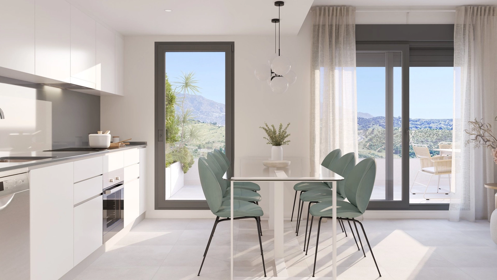 A view of the modern kitchen and dining space, opening onto a terrace with mountain views.