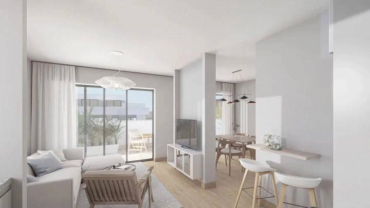 A view of the living room, seamlessly connected to the outdoor terrace space.