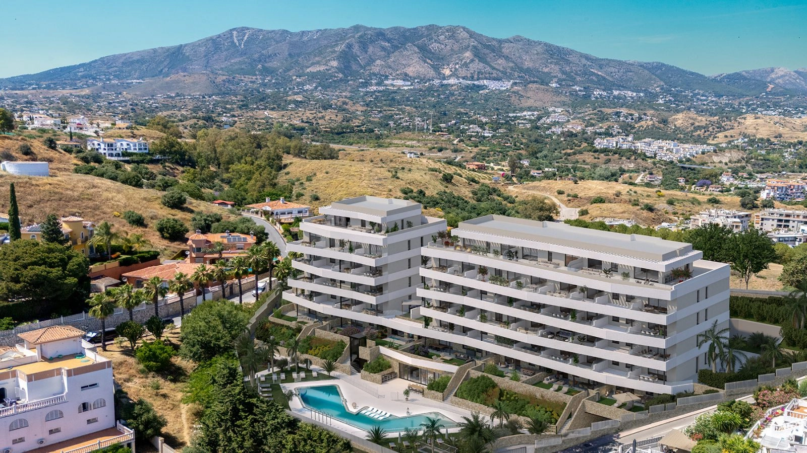 An aerial view of the development, nestled in the Mijas hills with the mountains as a stunning backdrop.
