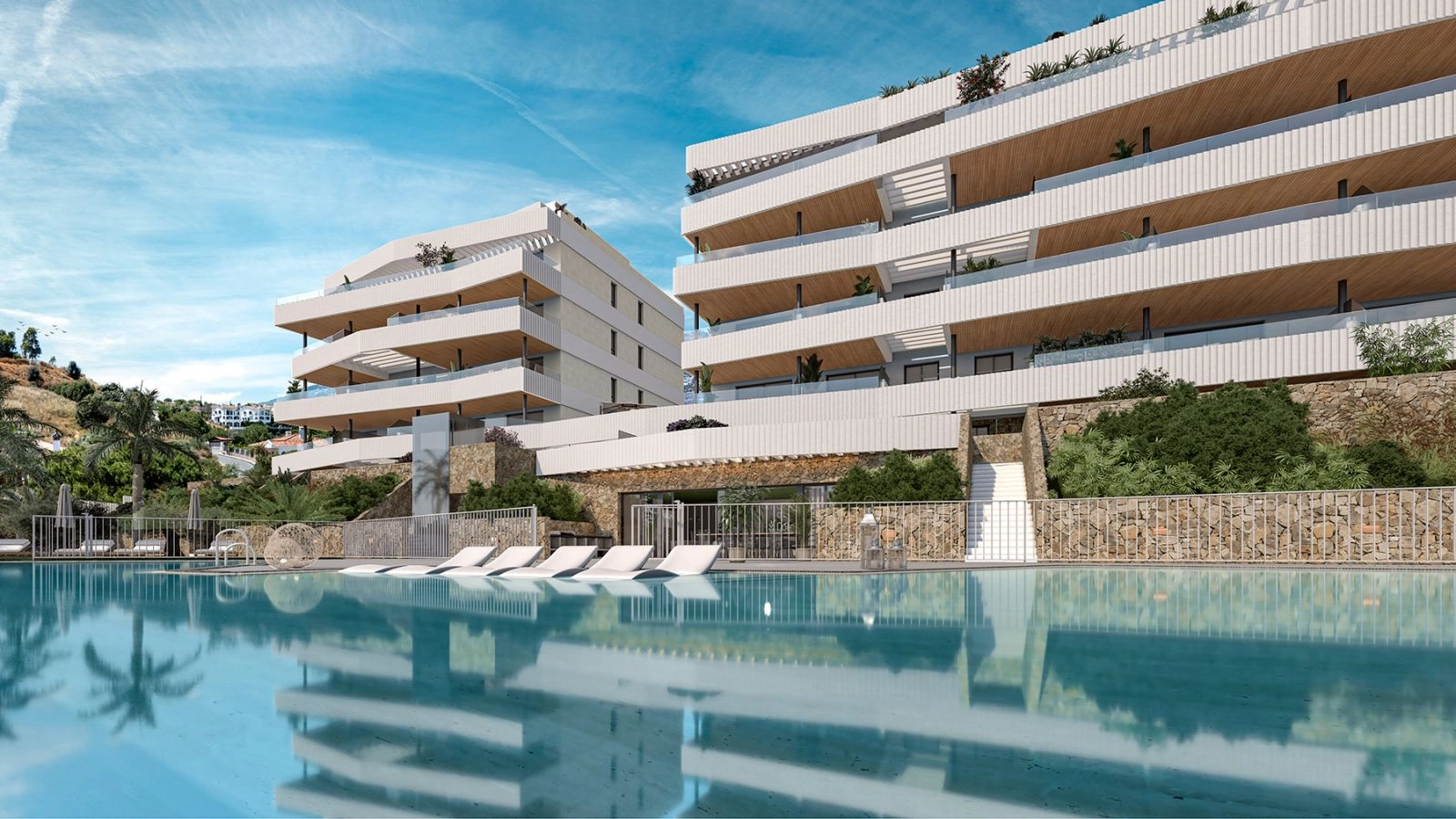 The inviting communal swimming pool and sunbathing area, surrounded by modern architecture and lush greenery.
