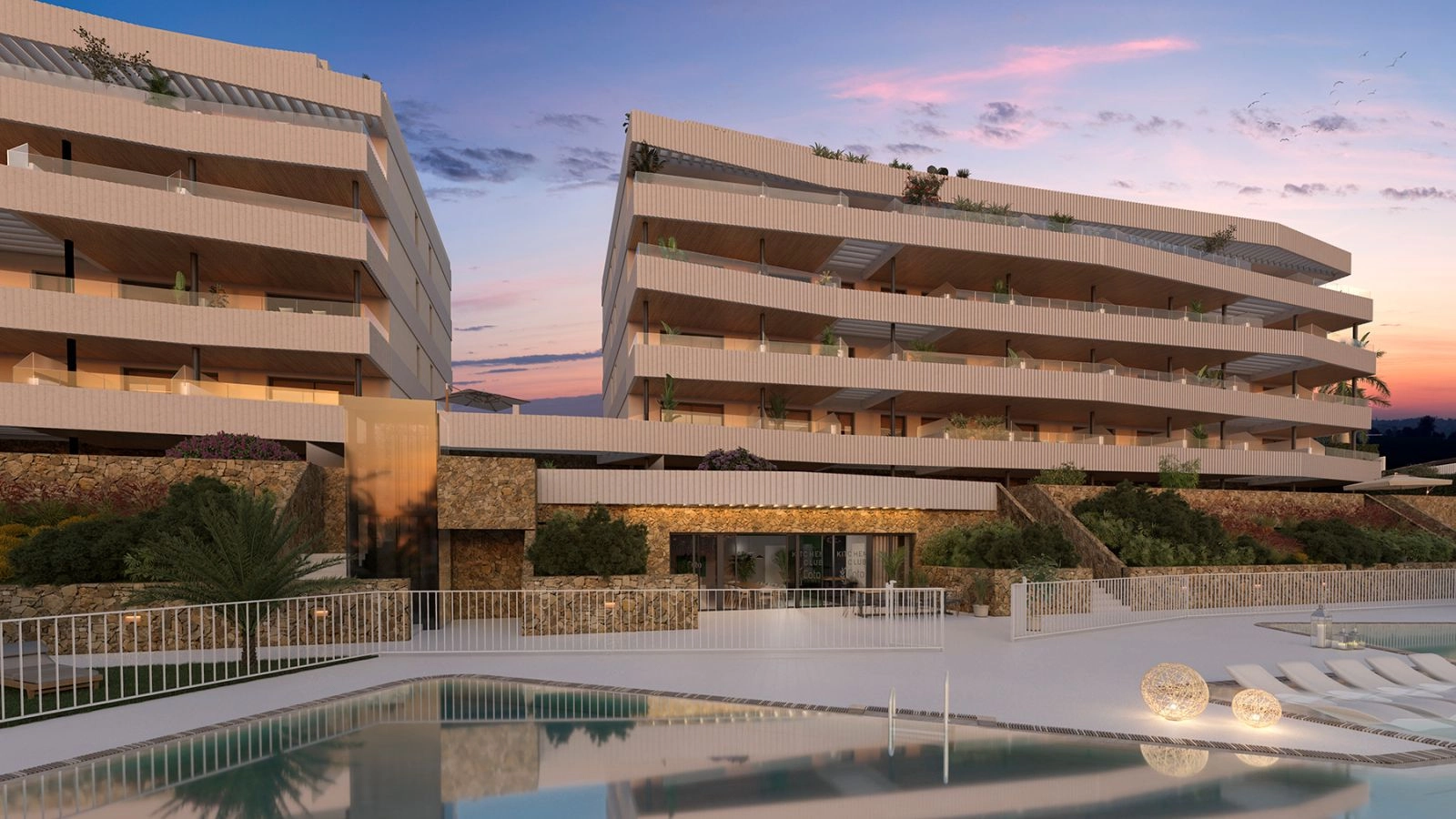 As dusk settles, the residence and pool area are beautifully illuminated, creating a tranquil and sophisticated ambiance.