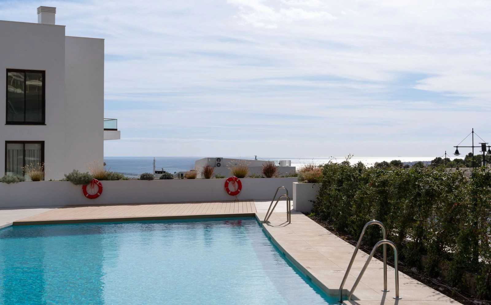 Enjoy the large communal swimming pool with beautiful sea views, surrounded by landscaped gardens.