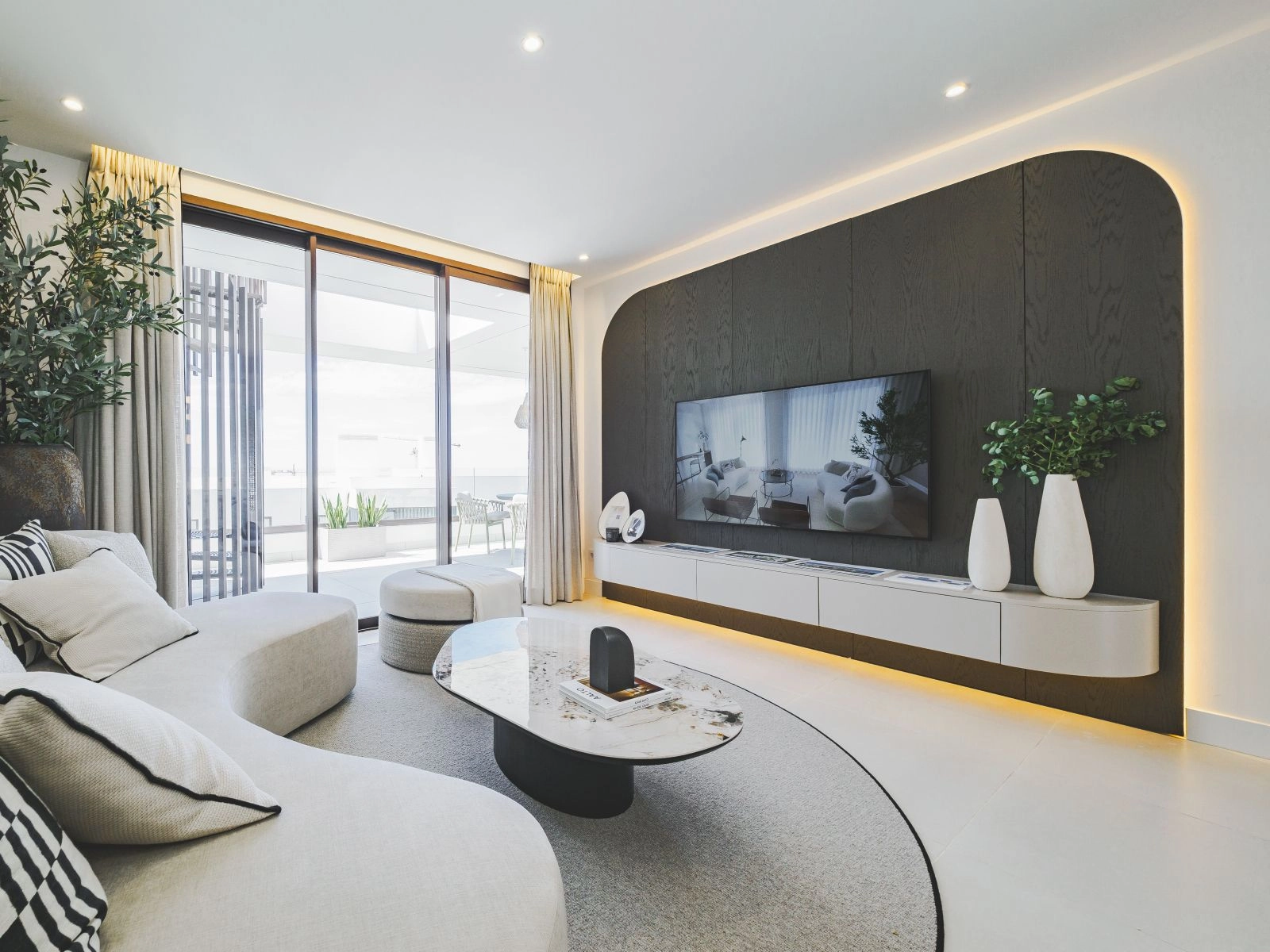 The bright and spacious living area is designed for comfort, flowing seamlessly onto the private terrace.