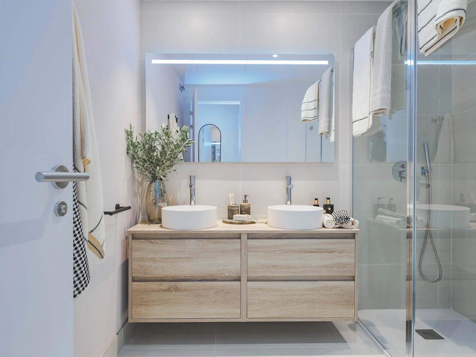 The main bathroom features contemporary design with a double vanity and high-quality fixtures.