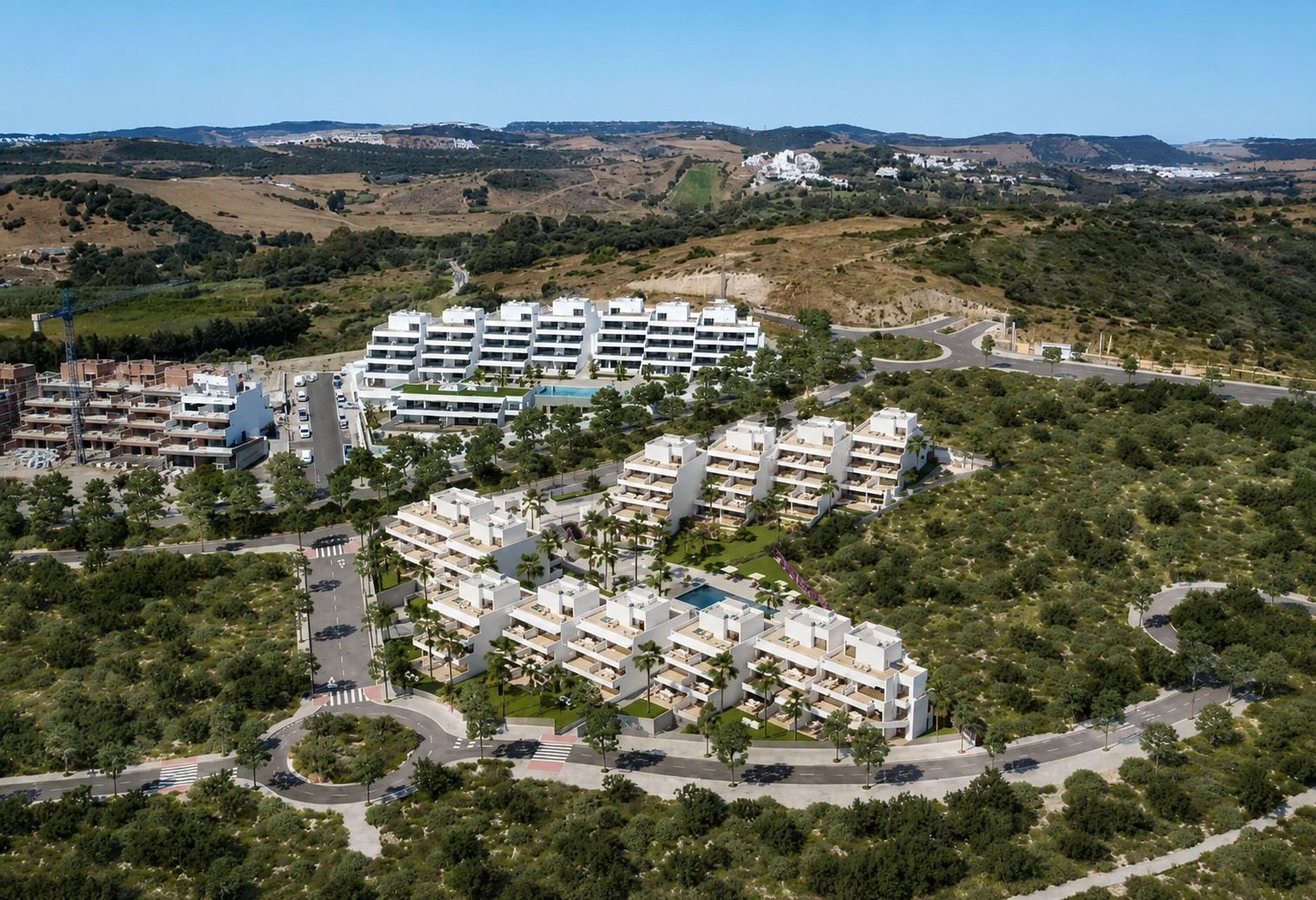 An aerial view of the development, showcasing its modern architecture and integration with the natural landscape of the Costa del Sol.