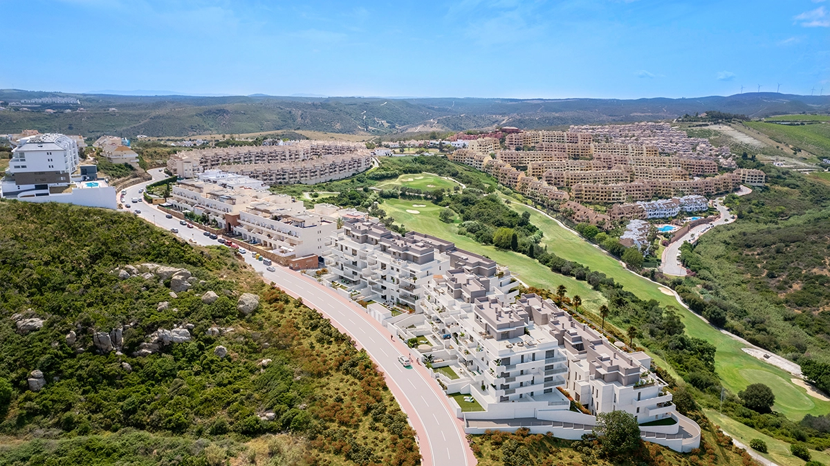 An aerial view of the development, perfectly integrated into the lush green landscape of the Costa del Sol with nearby golf courses.