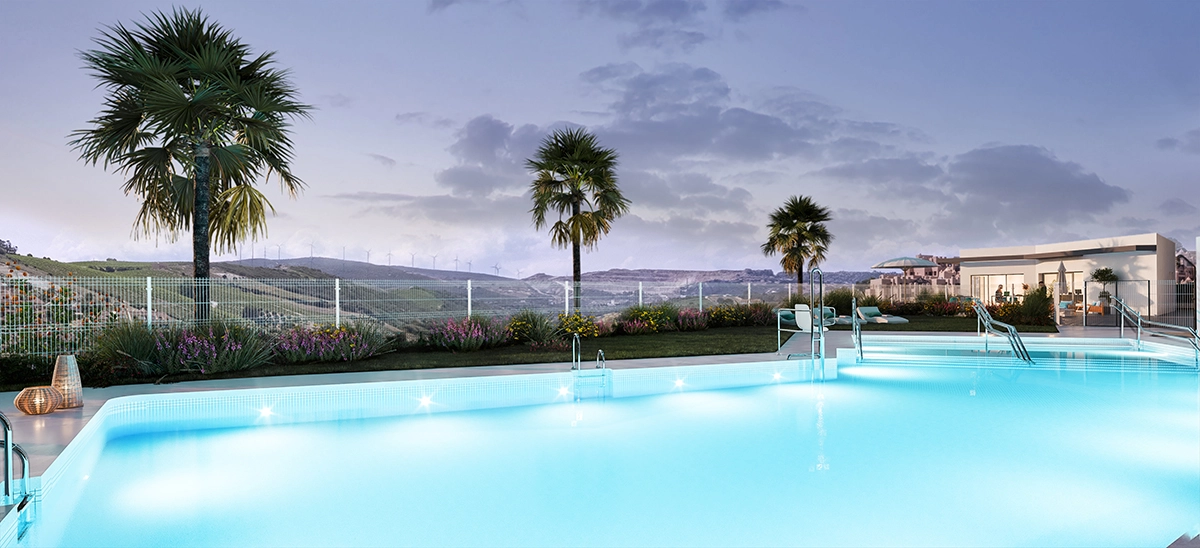 The communal swimming pool offers a tranquil setting for relaxation, surrounded by beautifully landscaped gardens.