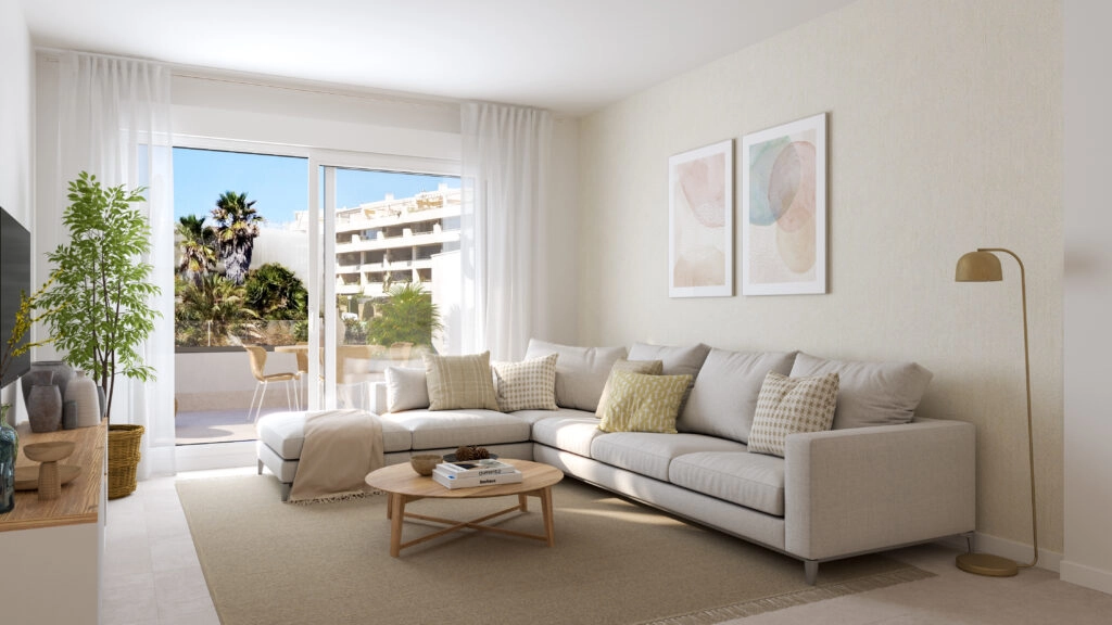 The bright and spacious living room connects seamlessly to the outdoor terrace, creating a perfect indoor-outdoor living space.