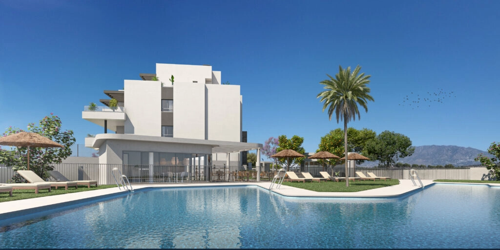 The large communal swimming pool is surrounded by relaxing sunbathing areas and beautiful gardens.