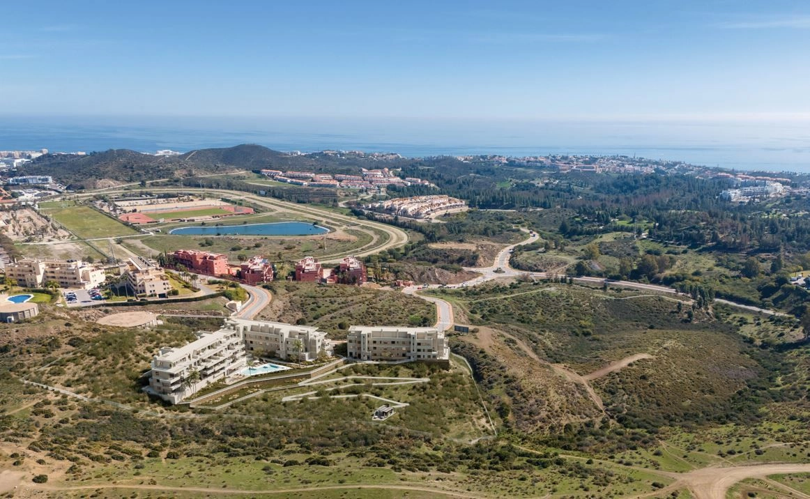 An aerial view showing the development's prime location in Mijas, close to the sea and local amenities.