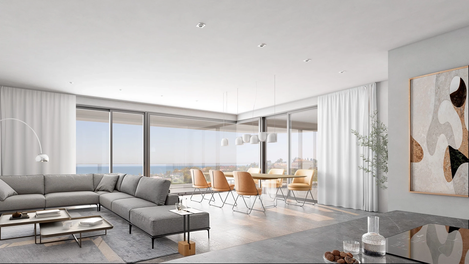 The bright and open living area seamlessly connects to the outdoors, with floor-to-ceiling windows framing the sea views.